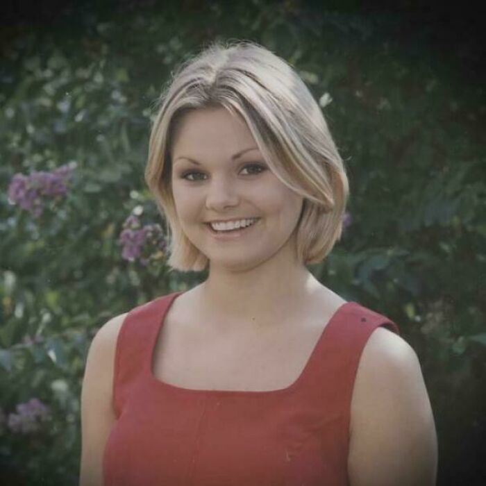 Young woman smiling outdoors surrounded by green foliage, representing unsettling mysteries that continue to fascinate and disturb.