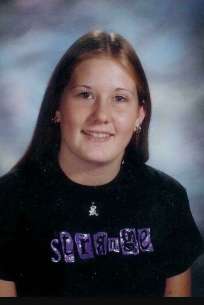 Teen girl wearing a black shirt with the word strange, representing unsettling mysteries that continue to fascinate and disturb.