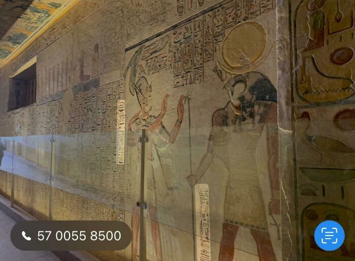 Ancient Egyptian wall carvings depicting mysterious scenes inside a dimly lit historical tomb attracting fascination.