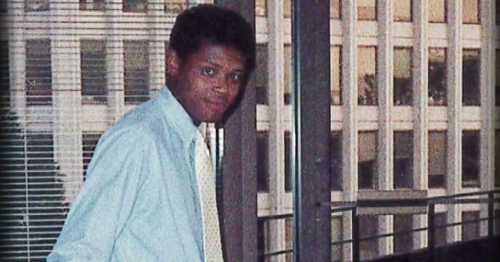 Young man in a light blue shirt standing indoors near windows, evoking themes of unsettling mysteries and fascination.