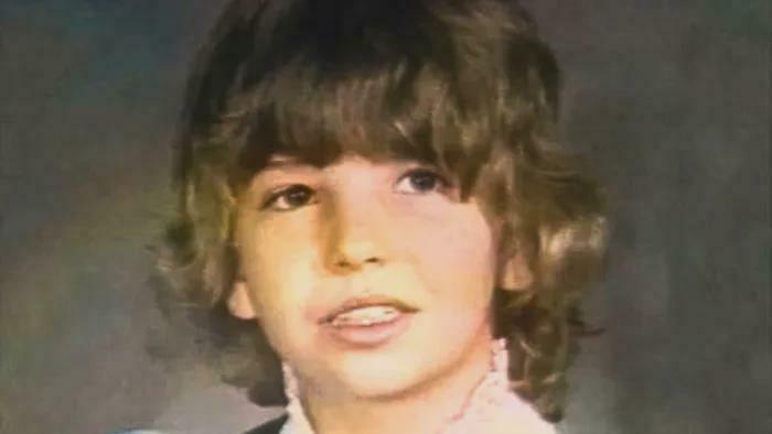 Young boy with curly hair looking to the side, an image related to unsettling mysteries that continue to fascinate and disturb.