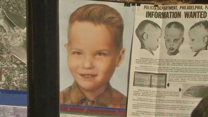 Photo of a vintage missing child poster displayed alongside documents related to unsettling mysteries and investigations.