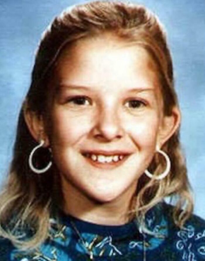 Young girl with blonde hair and hoop earrings smiling, related to unsettling mysteries that continue to fascinate and disturb.