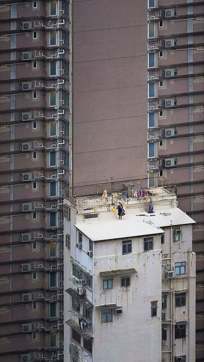 Small old building surrounded by tall, monotonous urban apartments