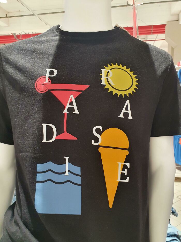 Black T-shirt with a hilariously bad design mixing letters and images of sun, cocktail, waves, and ice cream cone.