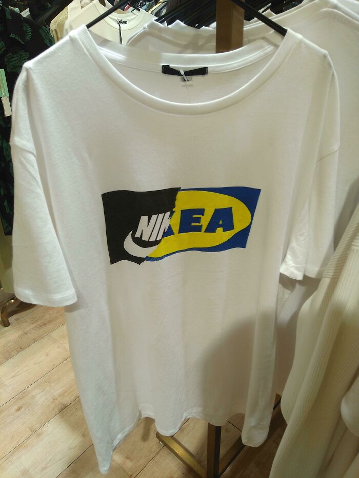 White T-shirt featuring a hilariously bad design blending Nike and Ikea logos, showcasing funny t-shirt design creativity.