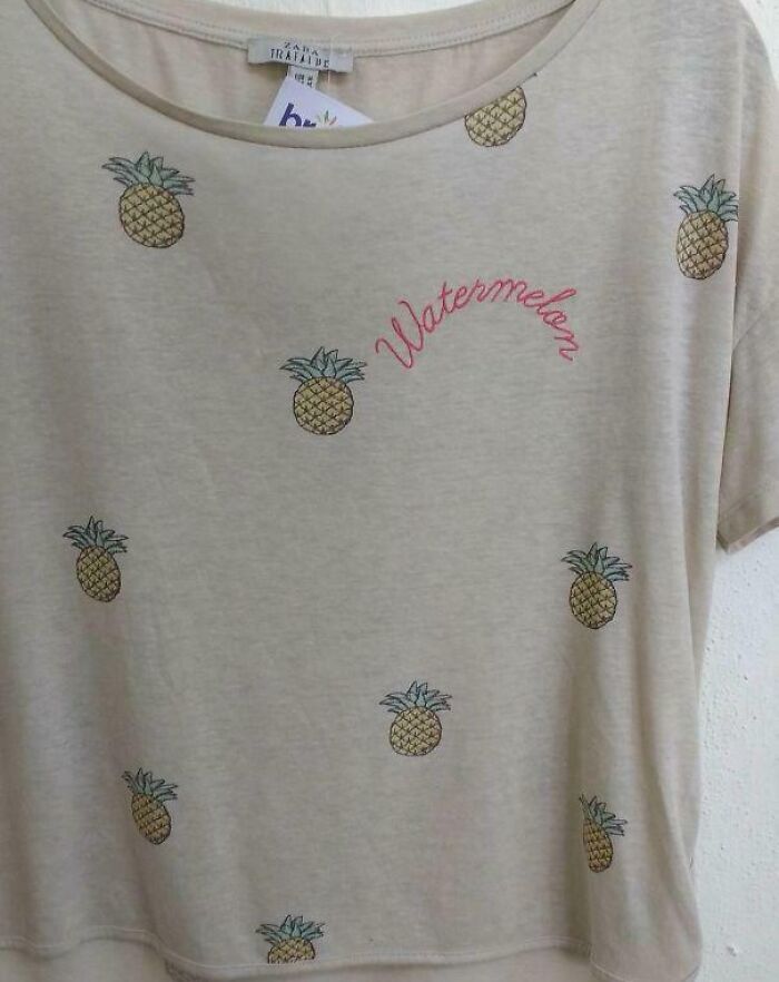 Beige T-shirt with pineapples printed all over and the word watermelon embroidered, showcasing hilariously bad t-shirt design.