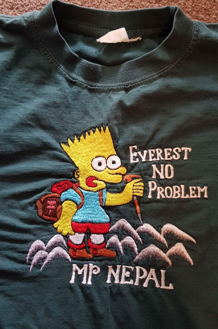 Bart Simpson hiking design with misspelled Everest no problem and MP Nepal on a dark green bad t-shirt design.