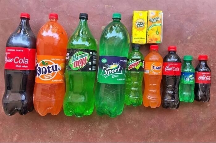 Various soda bottles and juice cartons with shamelessly copied famous brands displayed on a surface