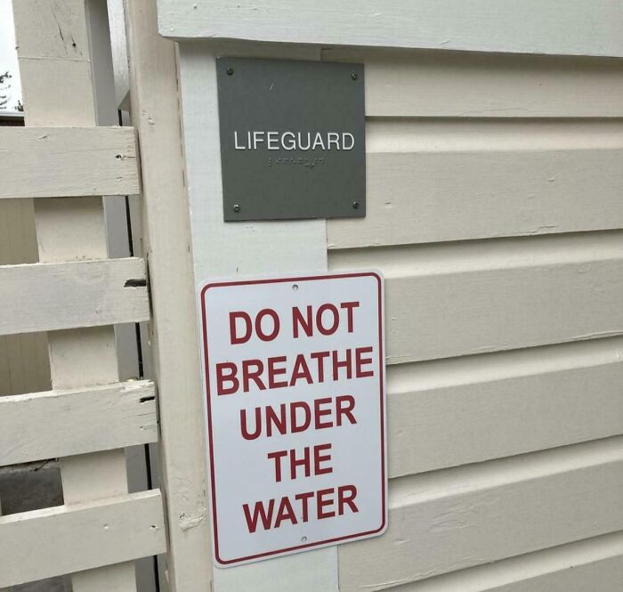Sign at lifeguard station humorously advising not to breathe under the water, a funny piece of advice with irony.