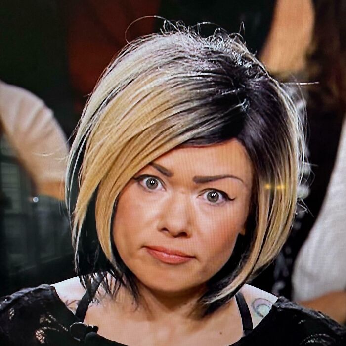 Woman with crazy eyebrows styled in an unusual shape, giving the appearance of eyebrows living their own lives on her face.