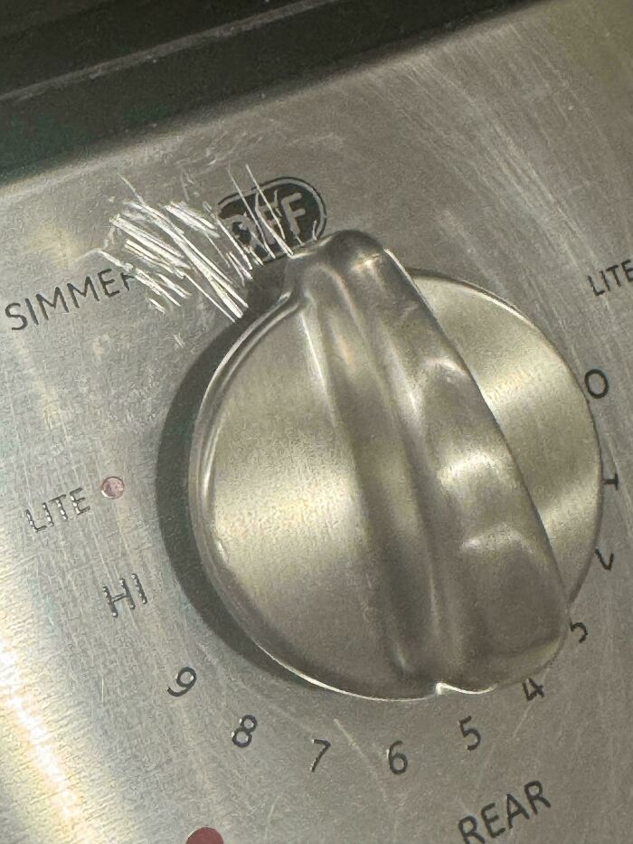 Close-up of a scratched stove k**b showing true colors of careless use, highlighting moments people had to shame friends online.