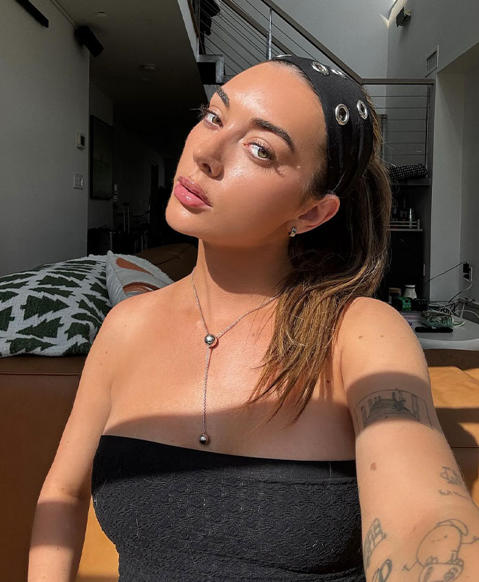 Brianna Chickenfry posing indoors with a black headband and tube top, discussing weight loss injections and warnings.