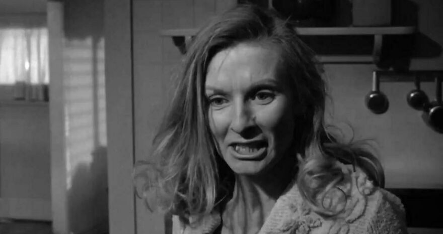 Woman with intense expression in a black and white scene, highlighting memorable supporting performances in film.