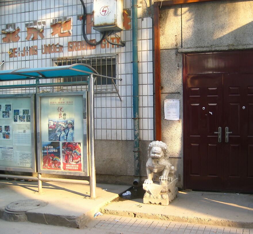 Stone lion statue outside an entrance to an underground city in Beijing, highlighting underground cities and their purpose.