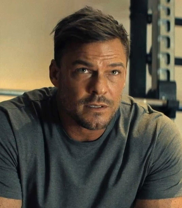 Alan Ritchson in a gym setting, looking serious, relating to investigation after altercation caught on video