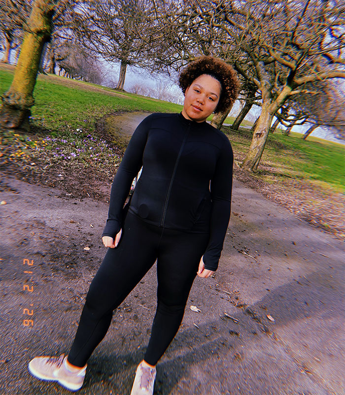 Bridgerton actress outdoors in athletic wear showing the impact of her mental health on her body in a natural setting.