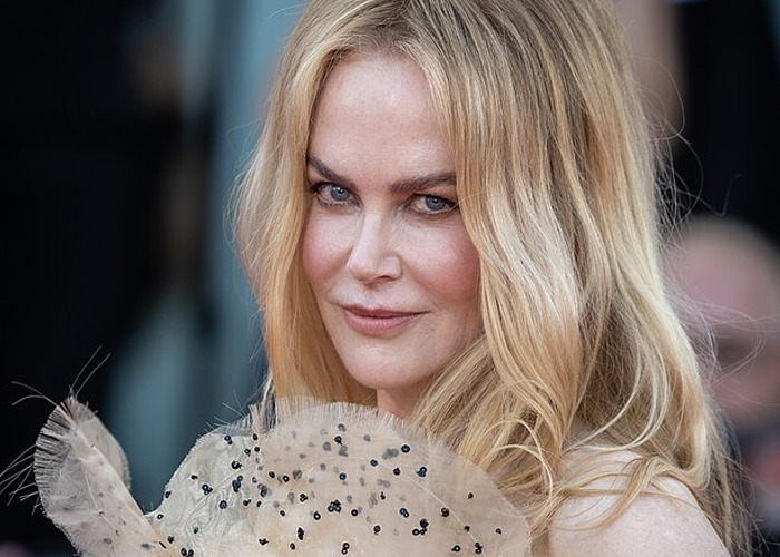 Blonde woman at an event wearing a delicate, beaded, sheer accessory, representing celebrities who turned out to be raging jerks.