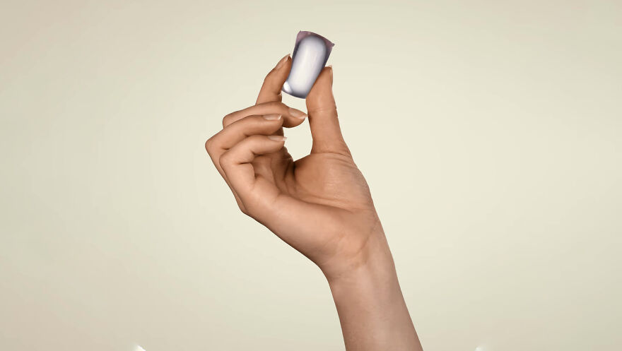 Hand holding a small, curious object against a plain background, highlighting its dazzling origins and unique design.