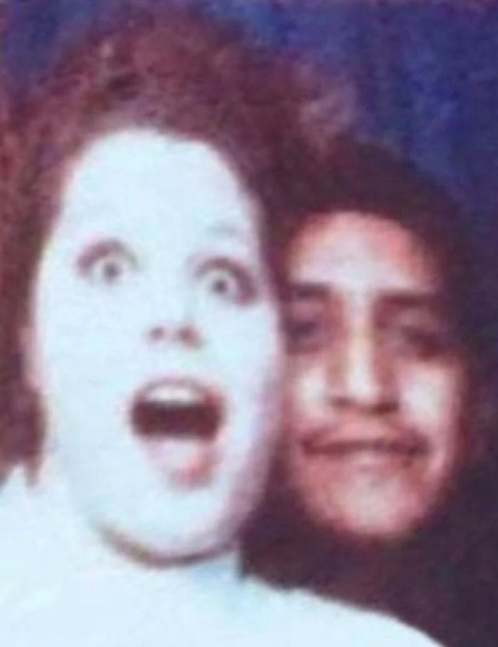 Blurry, unsettling photo of a surprised woman and a man, illustrating unsettling mysteries that fascinate and disturb viewers.