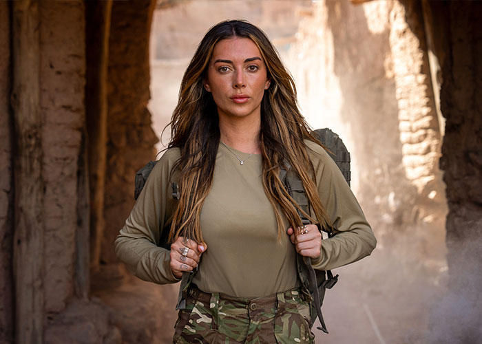 Brianna Chickenfry outdoors in camo pants and green top, delivering a serious message about weight loss injections.