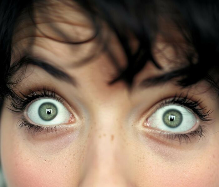 Close-up of a woman’s wide eyes expressing shock, illustrating amazing women brilliantly shutting down men’s creepy advances.