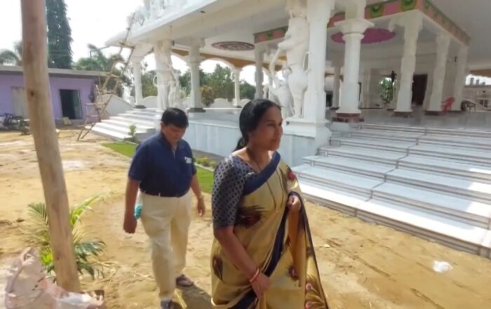 Two people walking near a temple, illustrating crazy things people did for love in unique cultural settings.