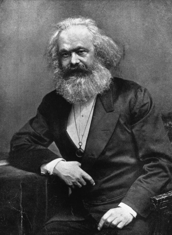 Portrait of a Karl Marx with a long beard, sitting and posing, representing influential leaders who changed history.