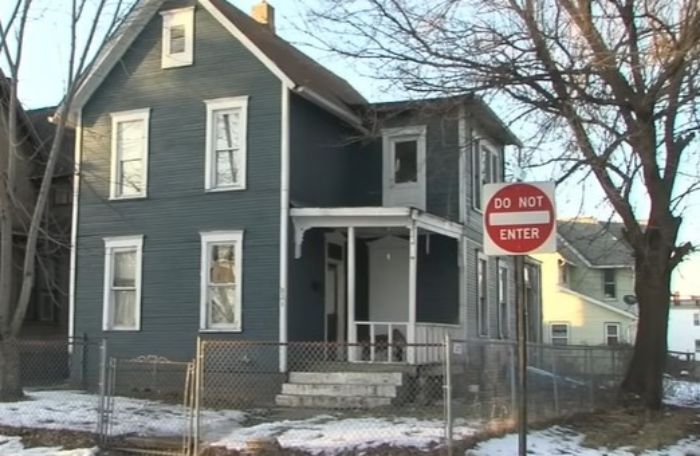 Two-story house behind a fenced yard with a do not enter sign, related to man accused of crimes at Daytona Beach.