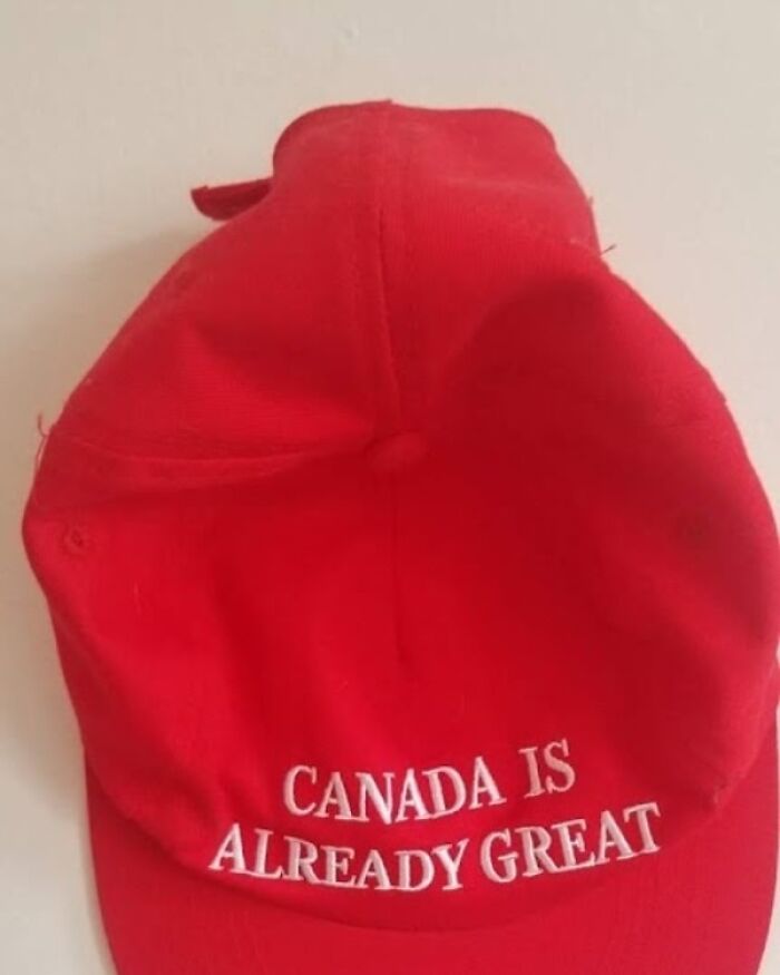 Red cap with white text saying Canada is already great, reflecting popular hilarious Canada memes and poutine culture.