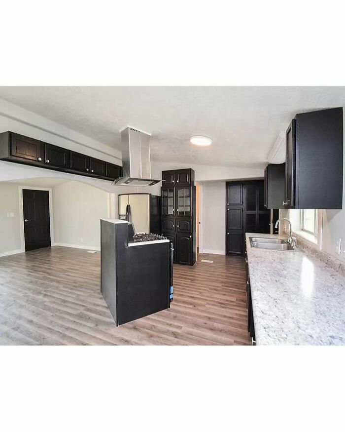 Kitchen interior showing home design disaster with stove placed awkwardly in center of room disrupting flow.