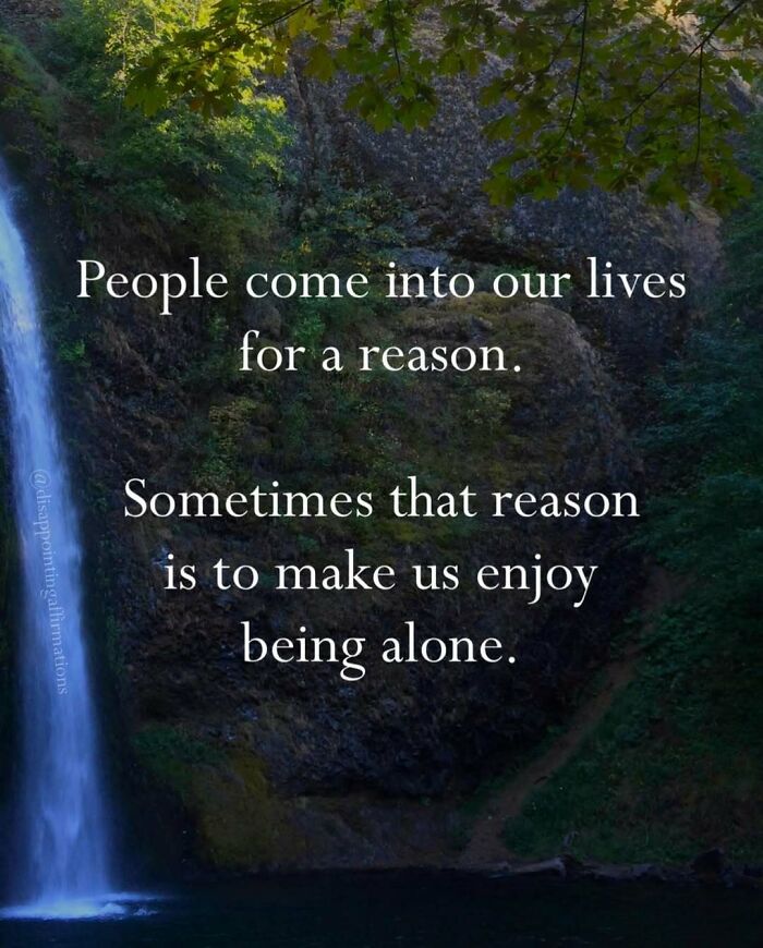 Scenic waterfall with anti-motivational affirmation about people making us enjoy being alone, highlighting anti-motivational affirmations.