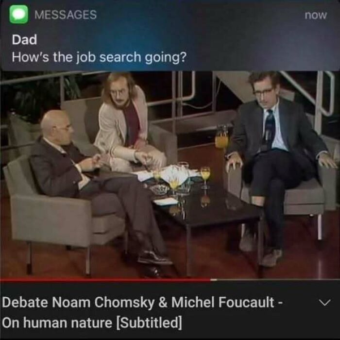 Three men sit in a debate on human nature with a text message about a job search, illustrating existential crisis memes.