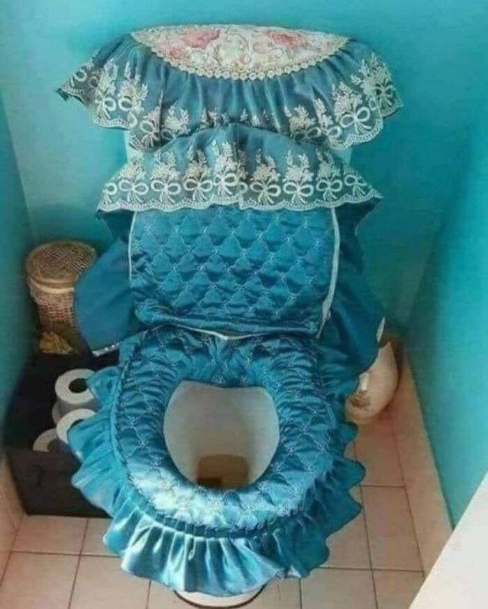 Toilet covered in an excessive and mismatched blue fabric set, illustrating home design disasters with poor aesthetics.