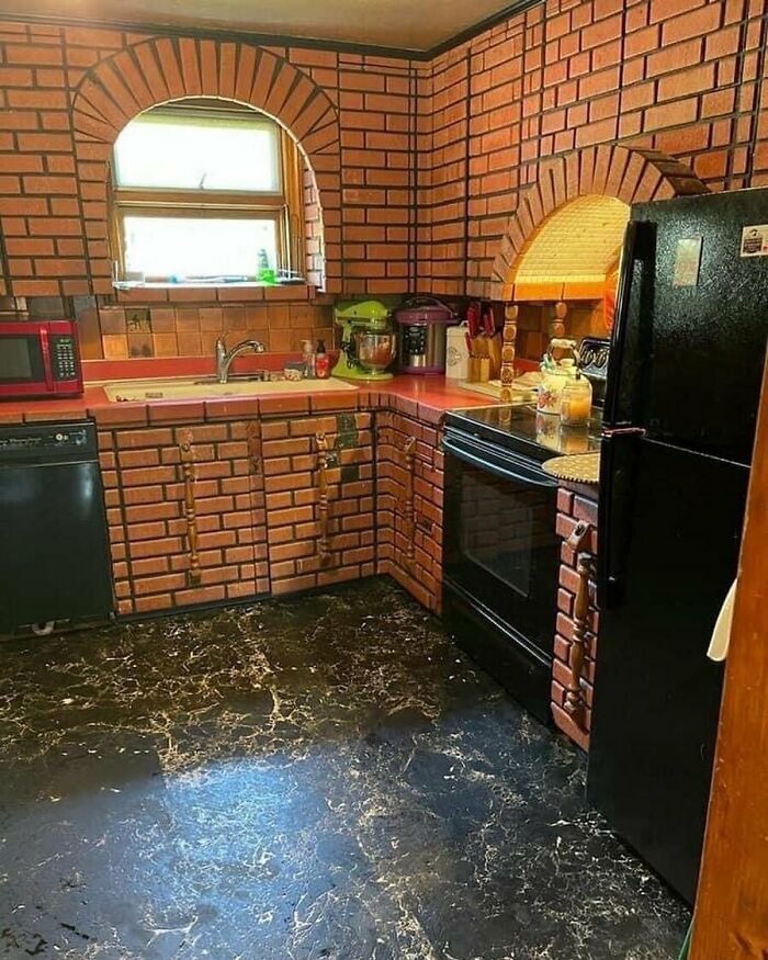 Kitchen with brick-patterned cabinets, walls, and arches showcasing home design disasters and poor aesthetic choices.
