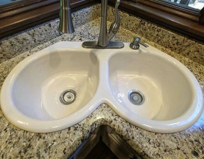Corner double sink with uneven and impractical design, showcasing one of the worst home design disasters and poor aesthetics.