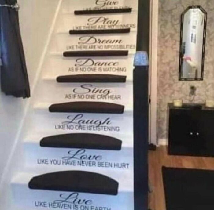 Staircase with black carpet strips and motivational home design text, illustrating a home design disaster.