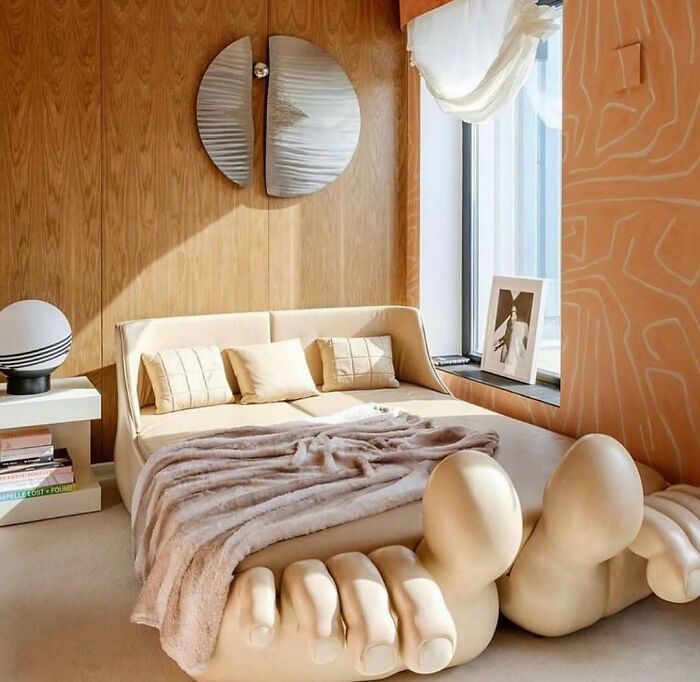 Unusual home design disaster featuring a bed with oversized toes as the base in a modern bedroom setting.