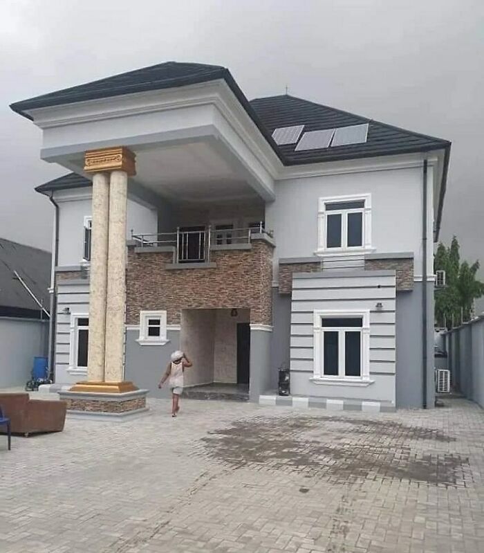 Modern house with mismatched oversized columns creating a glaring home design disaster in the front yard exterior.