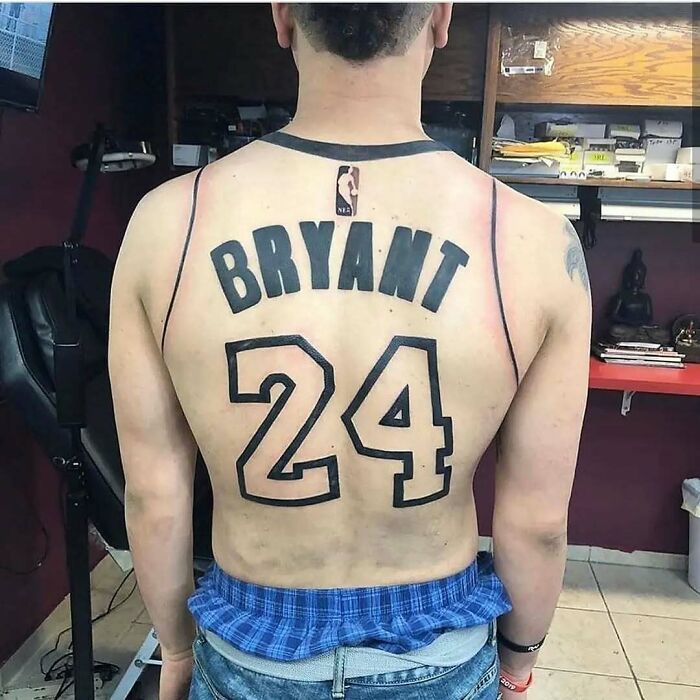 Back tattoo of a basketball jersey with the name Bryant and number 24, an example of ink fails and bad ideas.