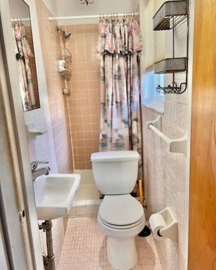 Tiny bathroom with poorly planned toilet and sink placement, showing a clear home design disaster and lack of aesthetic.