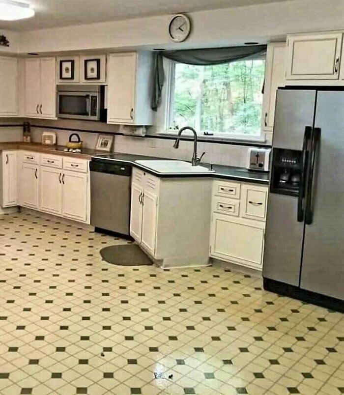 Kitchen with a sink placed awkwardly on a corner cabinet, illustrating home design disasters and poor aesthetic choices.