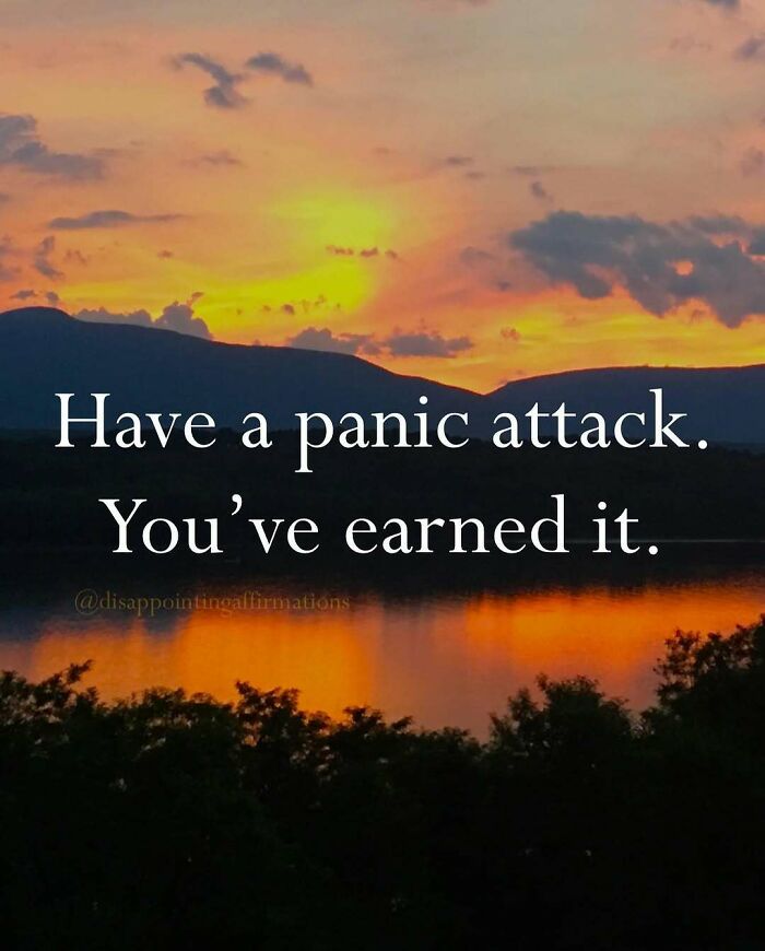 Sunset over mountains and lake with an anti-motivational affirmation about panic attacks and relatable feelings.