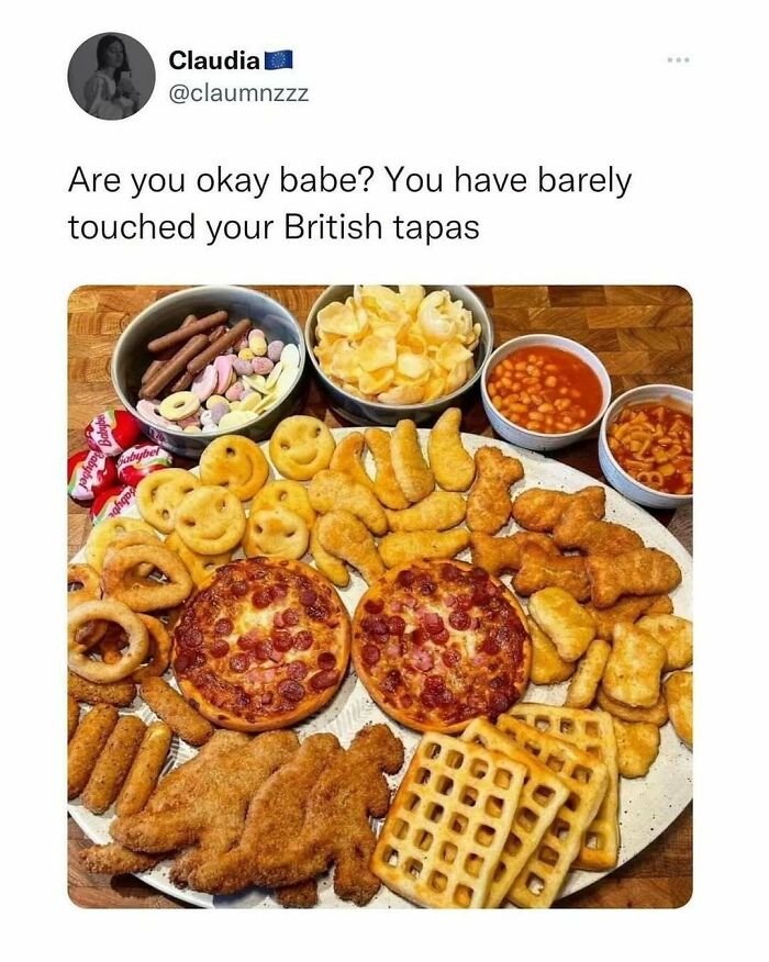 Twitter post humorously refers to a plate of British tapas with snacks, pizza, waffles, and beans, highlighting British humor memes.