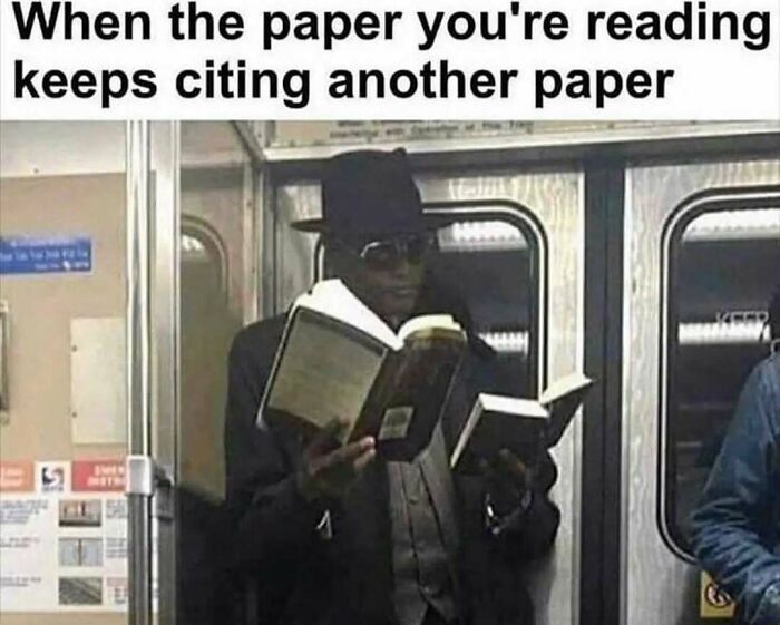 Man in a hat and sunglasses reading two books on a subway, illustrating memes about existential crisis and humor.