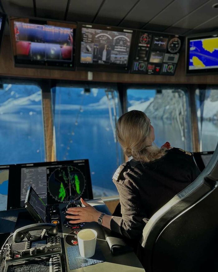 Woman using power tools and technology on a ship bridge, showcasing women choosing power tools over manicures in a technical role.