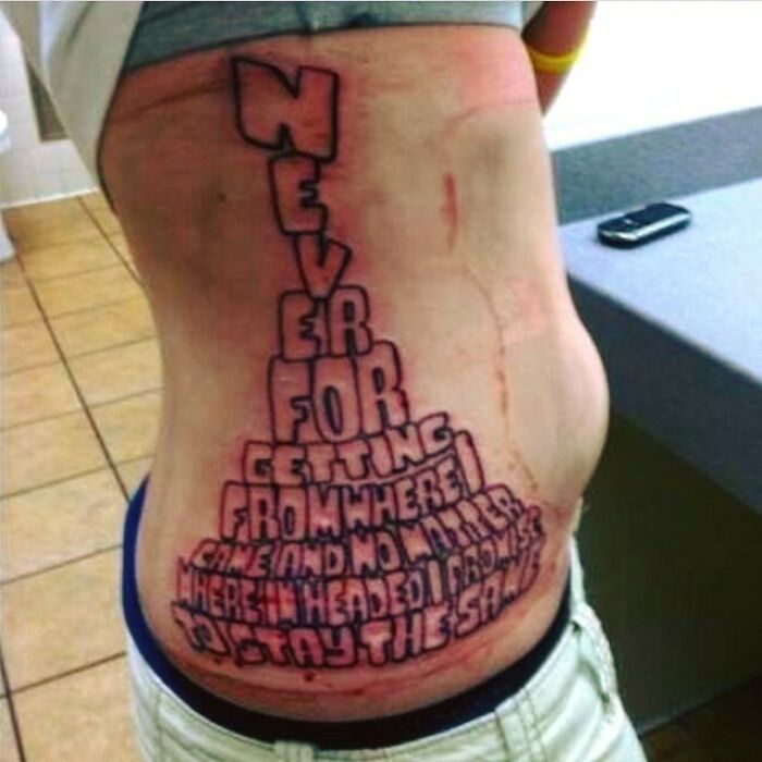 Tattoo fail on side torso with distorted text, showcasing one of the ink fails that turned bad ideas into permanent regrets.
