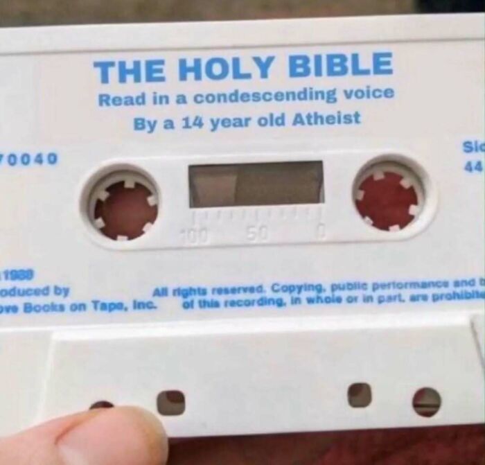 Cassette tape labeled The Holy Bible read by a 14-year-old atheist, meme referencing existential crisis humor.