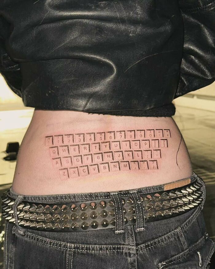 Tattoo of a keyboard on lower back showing ink fail example of bad ideas leading to permanent regrets.