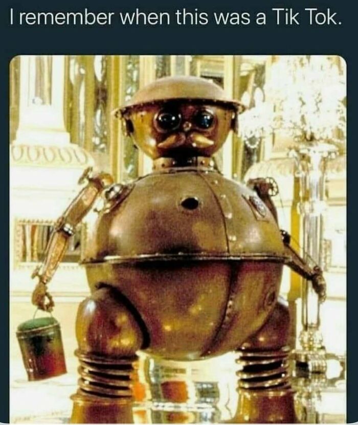 Vintage robot toy holding a bucket, representing nostalgic '90s moments from posts about parts of our lives lost.